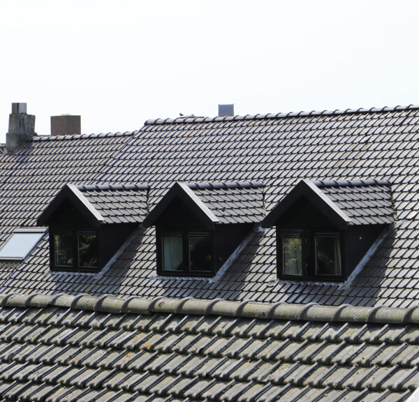 Icicles forming on a roof due to poor attic insulation and ventilation.