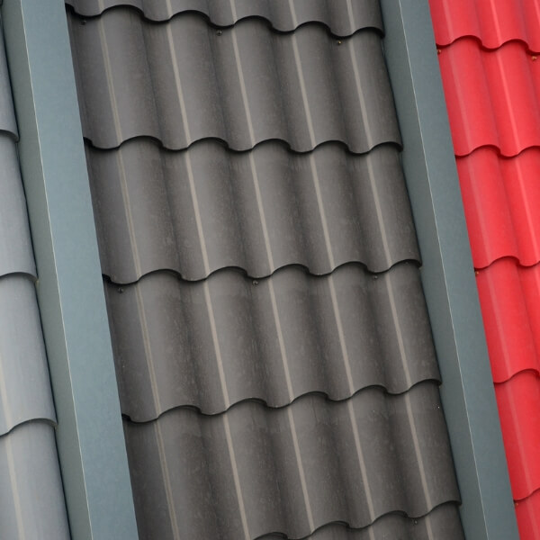 A roofer installing new flashing around a chimney to seal leaks.