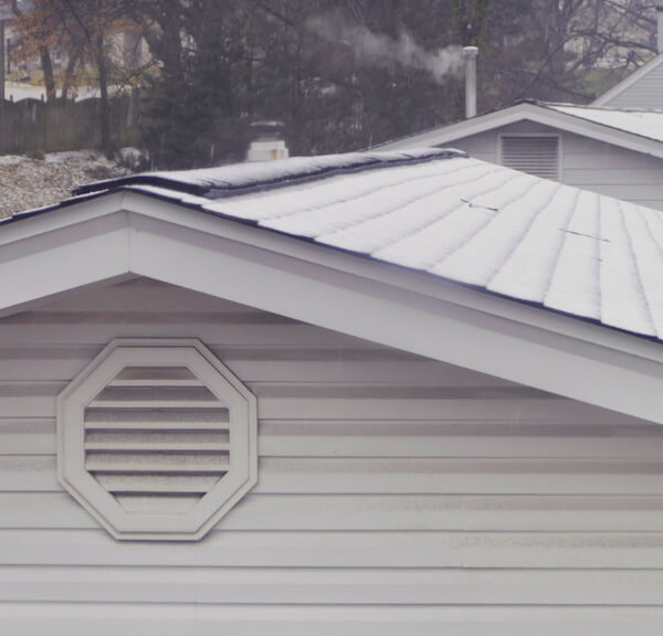 A thermal image showing heat loss through an uninsulated attic.